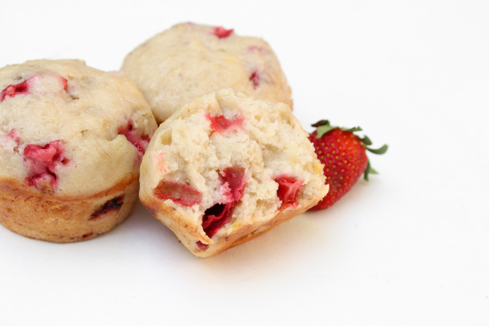 Angled view of a strawberry banana muffin cut in half